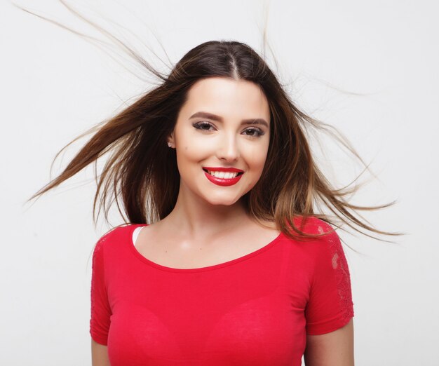 Portrait of a beautiful  girl with fluttering hair over white background