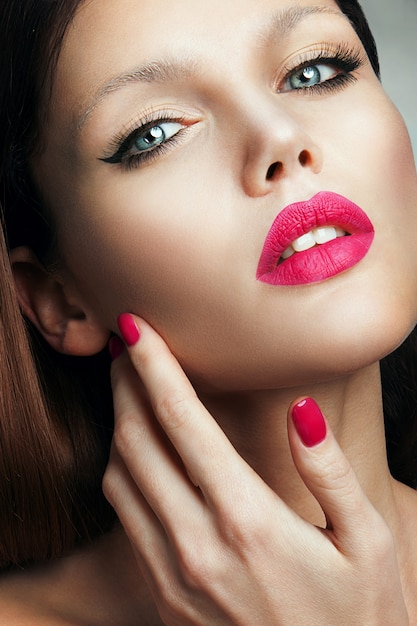 Portrait of beautiful girl with pink lips.