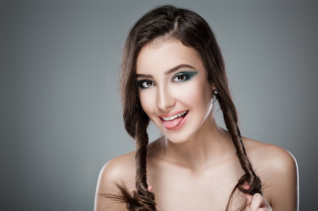 portrait of beautiful glamour woman with a green evening make-up on dark background