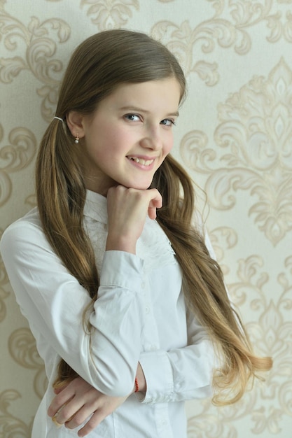 Portrait of a beautiful happy little girl posing at home