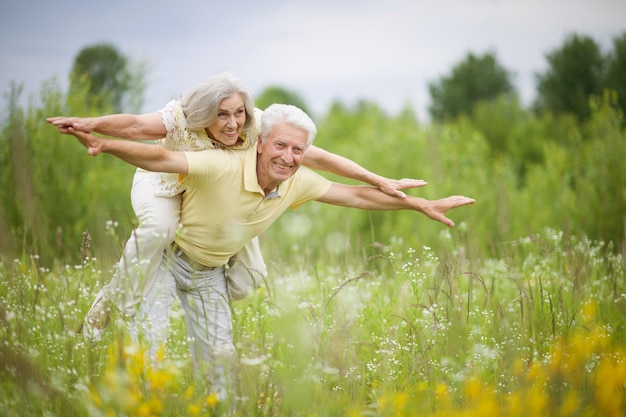 Portrait of beautiful happy senior couple in the park