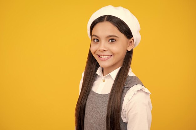 portrait of beautiful happy smiling teenage girl on yellow studio background happy face positive and smiling emotions of teenager girl