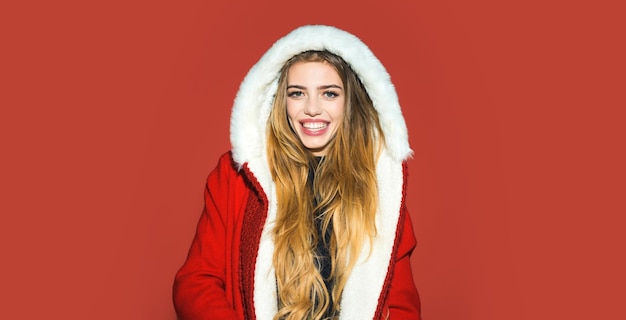 Portrait of a beautiful happy smiling woman celebrate winter christmas holidays isolated on red back