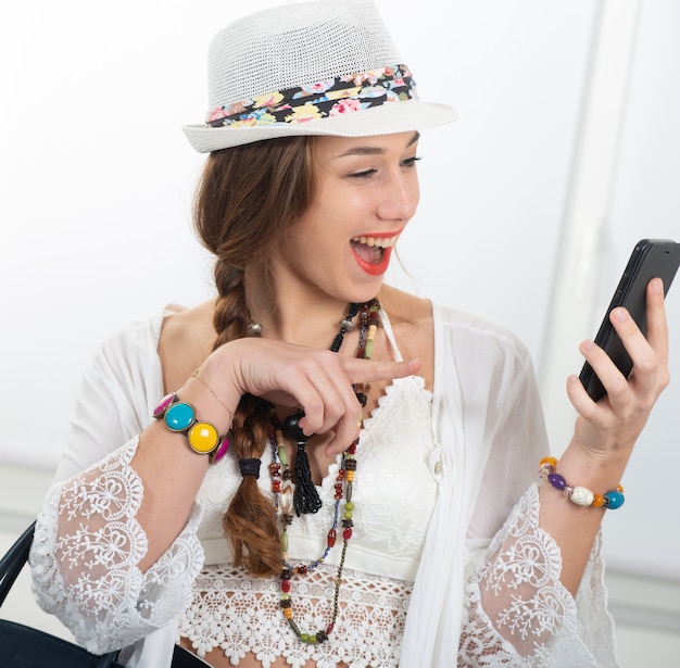 Portrait of beautiful hippie girl with smartphone