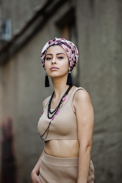 Portrait of a beautiful Indian girl in scarf Young hippie style woman wearing handmade jewelry