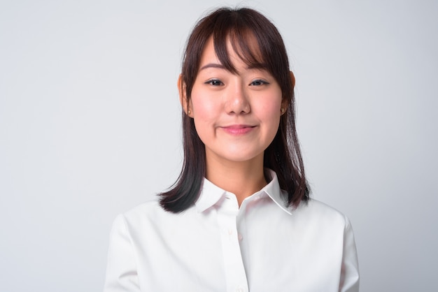 Portrait of beautiful Japanese businesswoman on white