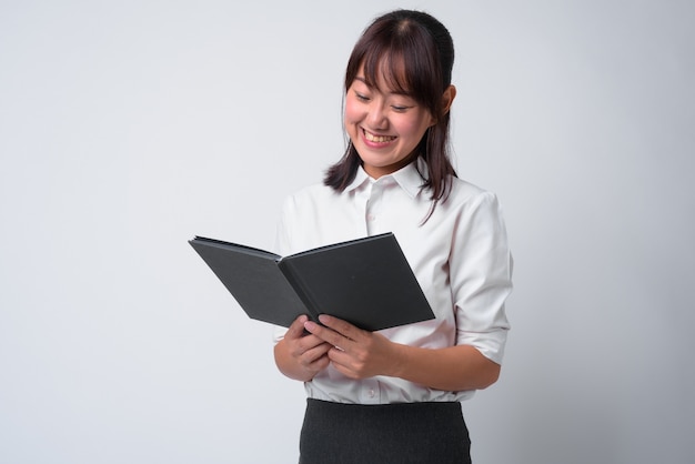 Portrait of beautiful Japanese businesswoman on white