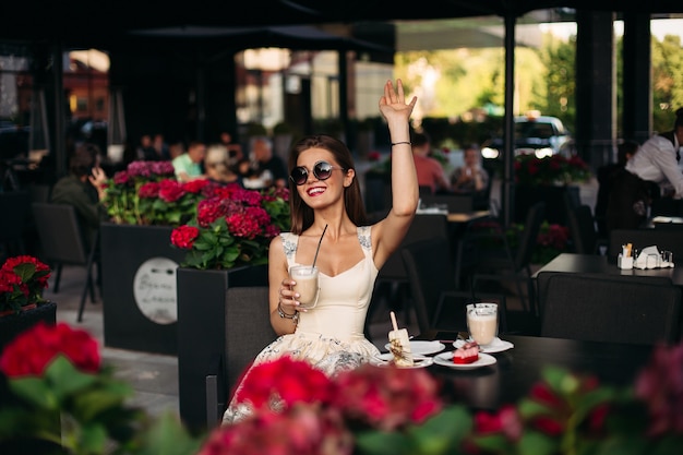 Portrait of a beautiful joyful brunette woman in a cafe