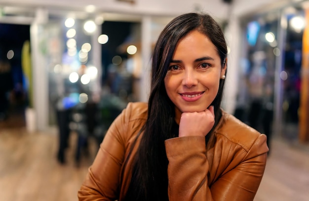 Portrait beautiful latin woman looking at camera smiling happy indoors