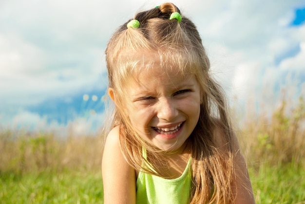 Portrait of beautiful little girl in a meadow