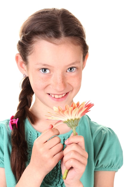 Portrait of beautiful little girl with gerbera flower isolated on white