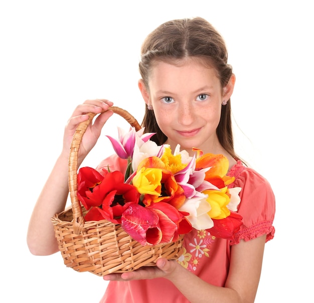 Portrait of beautiful little girl with tulips in basket isolated on white