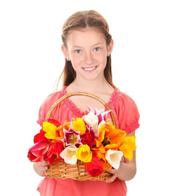 Portrait of beautiful little girl with tulips in basket isolated on white