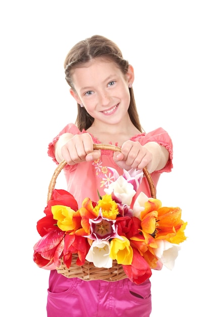Portrait of beautiful little girl with tulips in basket isolated on white