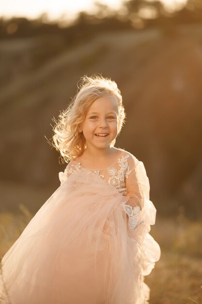 Portrait of a beautiful little princess girl in a pink dress.