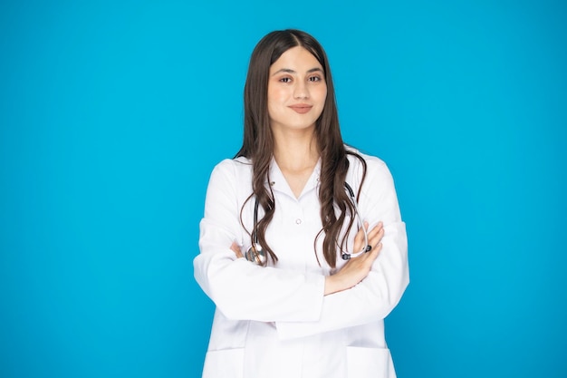 Portrait of beautiful mature woman doctor in lab coat for hospital shooting in studio