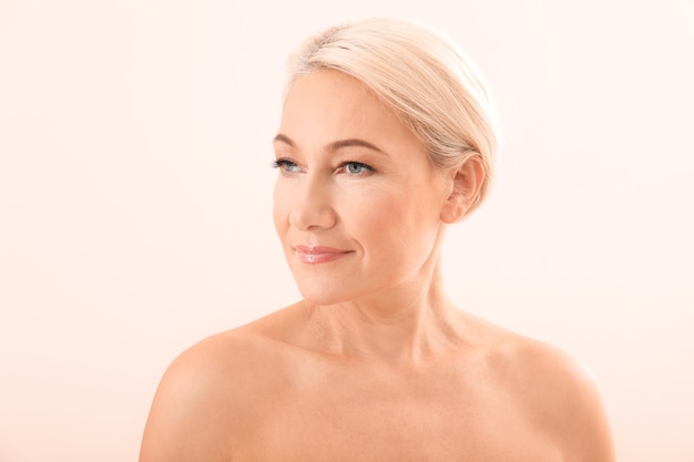 Portrait of beautiful mature woman on light background Skin care concept