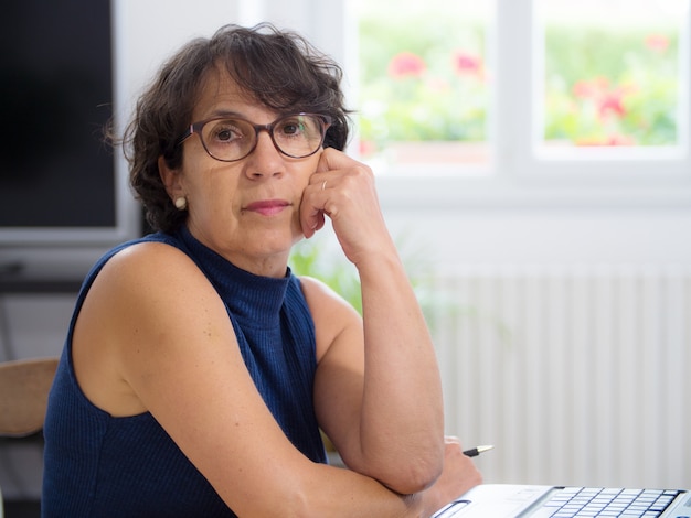 Portrait of a beautiful mature woman with glasses