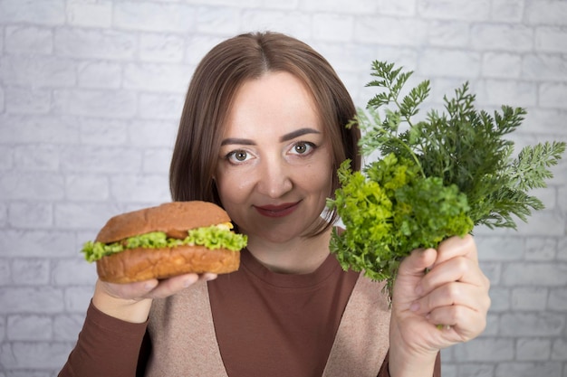 Portrait of a beautiful middleaged brunette woman offering a choice of products for proper and malnutrition