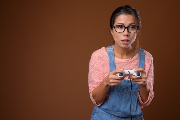Portrait of beautiful nerd woman playing games
