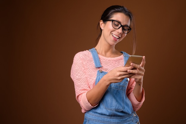 Portrait of beautiful nerd woman using phone