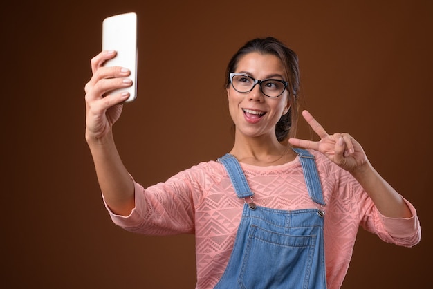 Portrait of beautiful nerd woman using phone