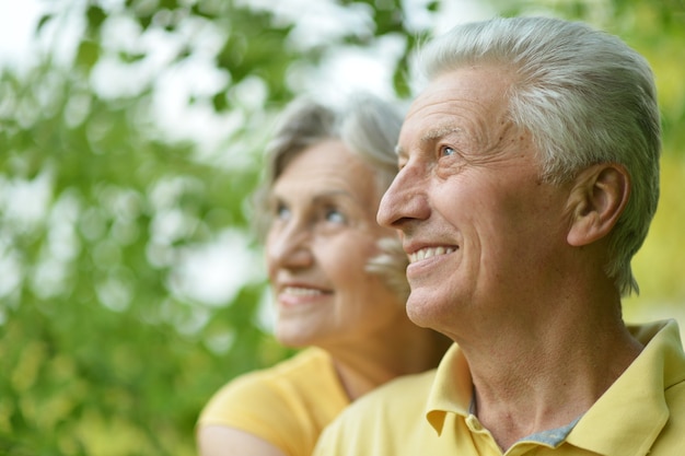 Portrait of beautiful old people embracing outdoors on the walk