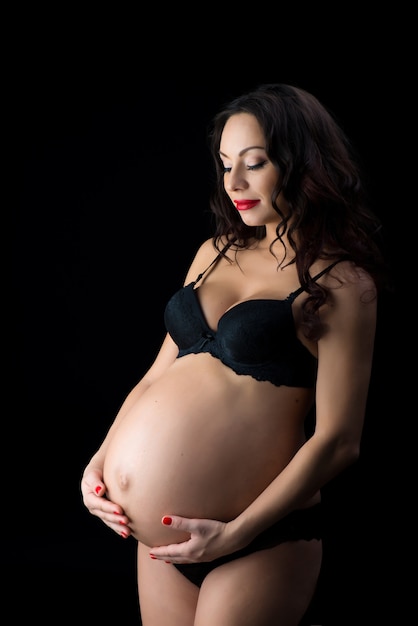 Portrait of a beautiful pregnant woman in black lingerie