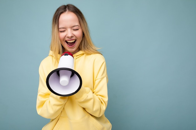 Portrait of beautiful pretty positive happy smiling blonde young woman with sincere emotions wearing