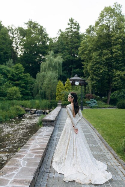 Portrait of a beautiful princess girl in the garden view from the back