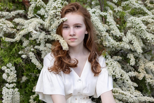 Photo portrait of a beautiful red-haired spring girl