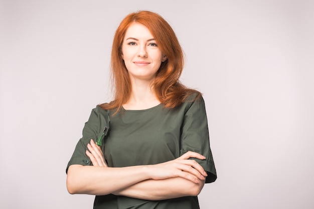 Portrait of beautiful redhead woman posing in white background