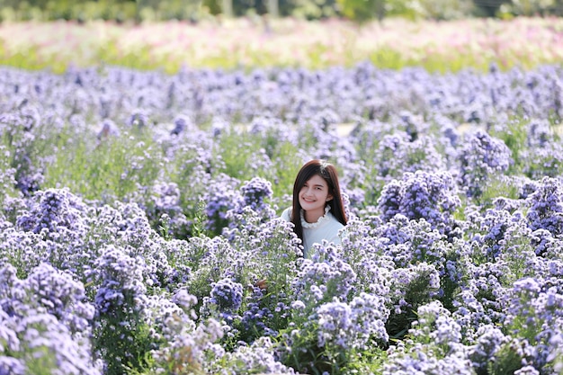 Portrait of a beautiful romantic woman in fairy field of Margaret, Teenage girl in a garden of flowers.