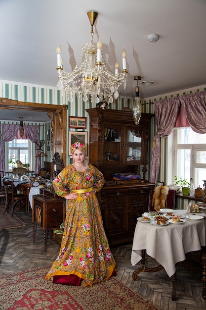 Portrait of a beautiful russian girl in a kokoshnik and traditional dress