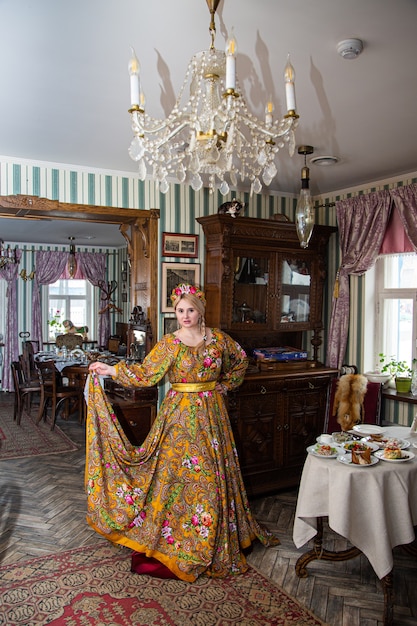 Portrait of a beautiful russian girl in a kokoshnik and traditional dress