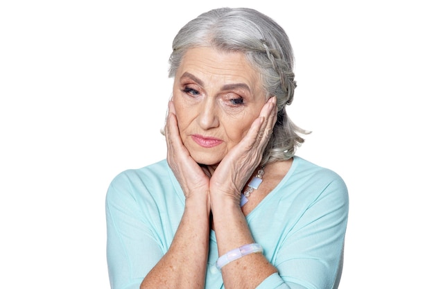 Portrait of a beautiful sad senior woman isolated on white background