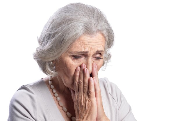 Portrait of beautiful sad senior woman posing isolated on white background