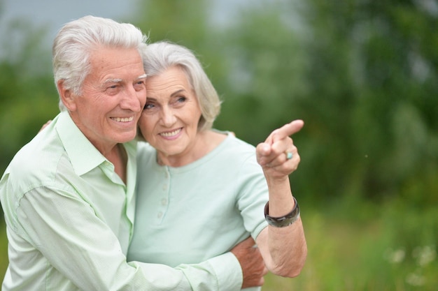 Portrait of beautiful senior couple hugging in the park