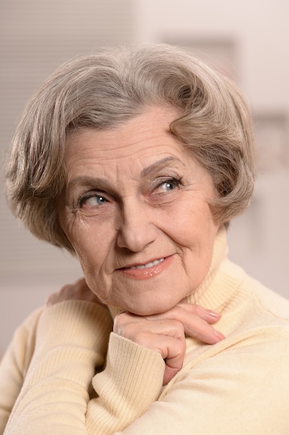 Portrait of beautiful senior woman  on background