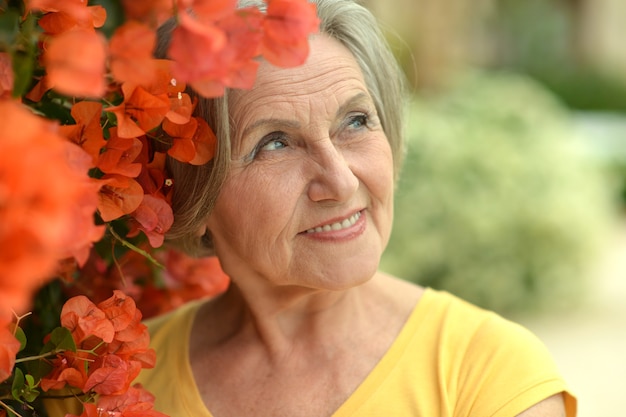 Portrait of beautiful senior woman outdoor in summer park