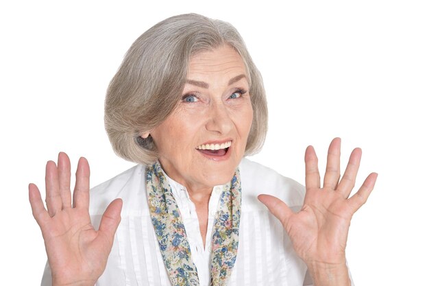 Portrait of beautiful senior woman posing against white background