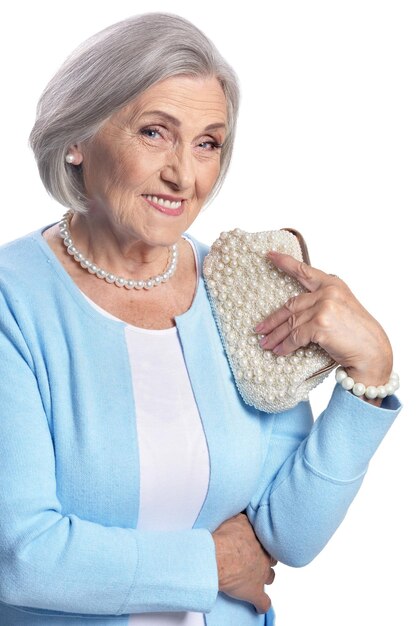 Portrait of beautiful senior woman posing against white background