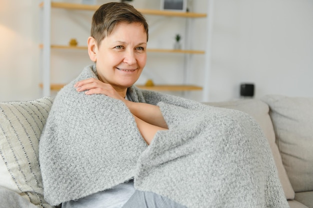 Portrait of a beautiful senior woman smiling at home old\
granny