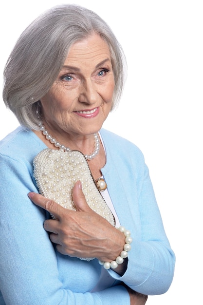 Portrait of beautiful senior woman with purse isolated on white background