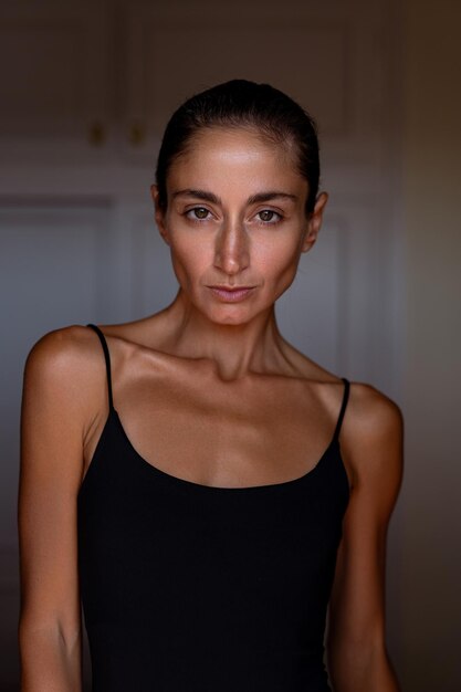 Photo portrait of a beautiful sexy brunette in a black bodysuit