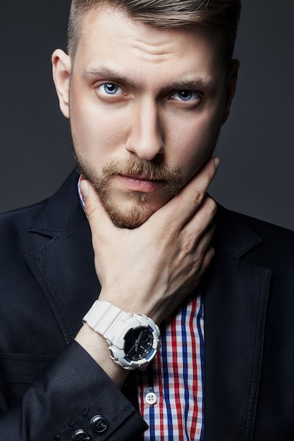 Portrait of beautiful sexy brutal men. Blonde with beautiful shiny hair. A businessman, a Manager, a man in a shirt. Guy with the clock on the hand