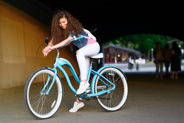 Portrait of a beautiful sexy girl with a bicycle in the city