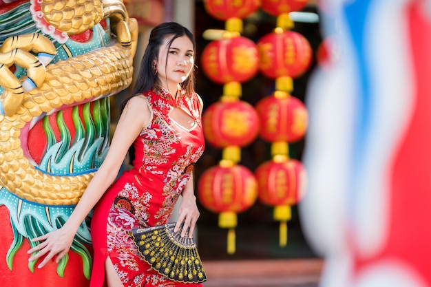 Portrait beautiful smiles Asian young woman wearing red traditional Chinese cheongsam