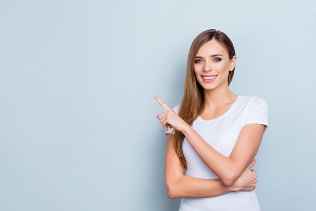 Portrait of beautiful smiley woman pointing