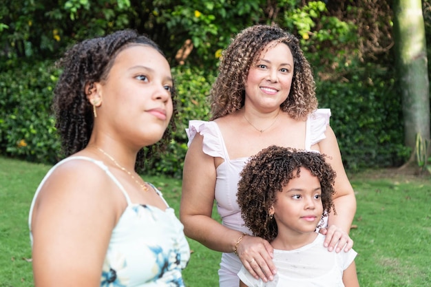 Portrait of a beautiful smiling mother standing with her daughters